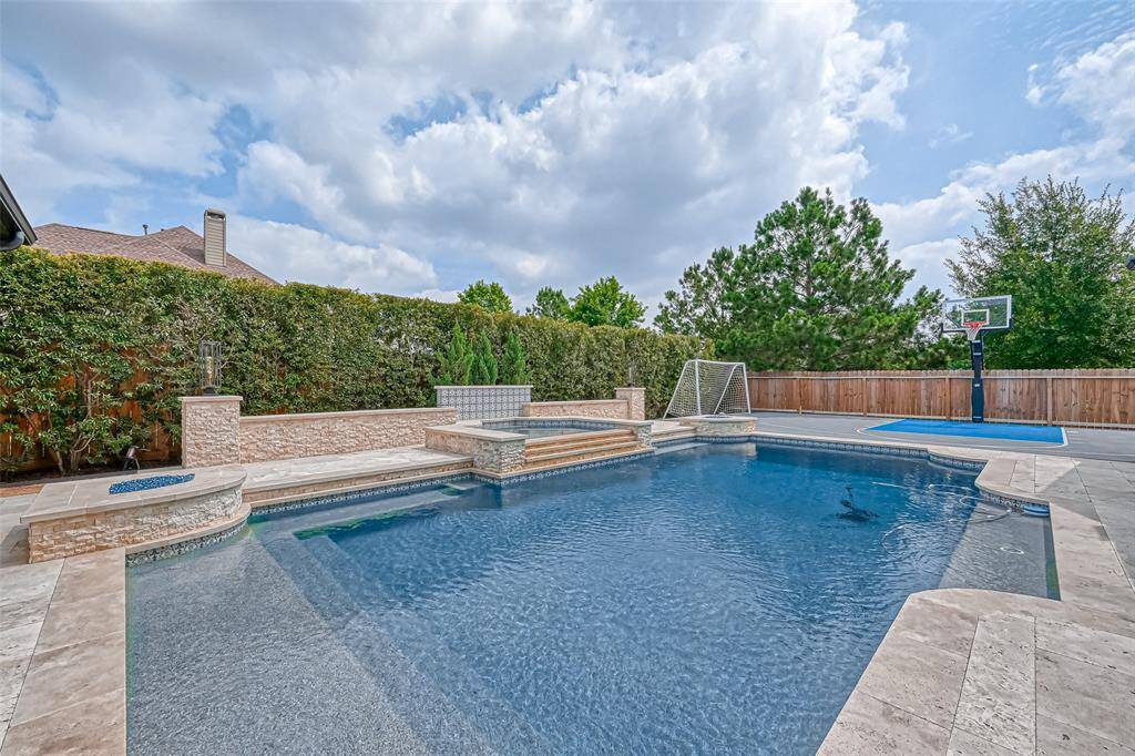 Your backyard sanctuary with pool, hot tub and spots court.