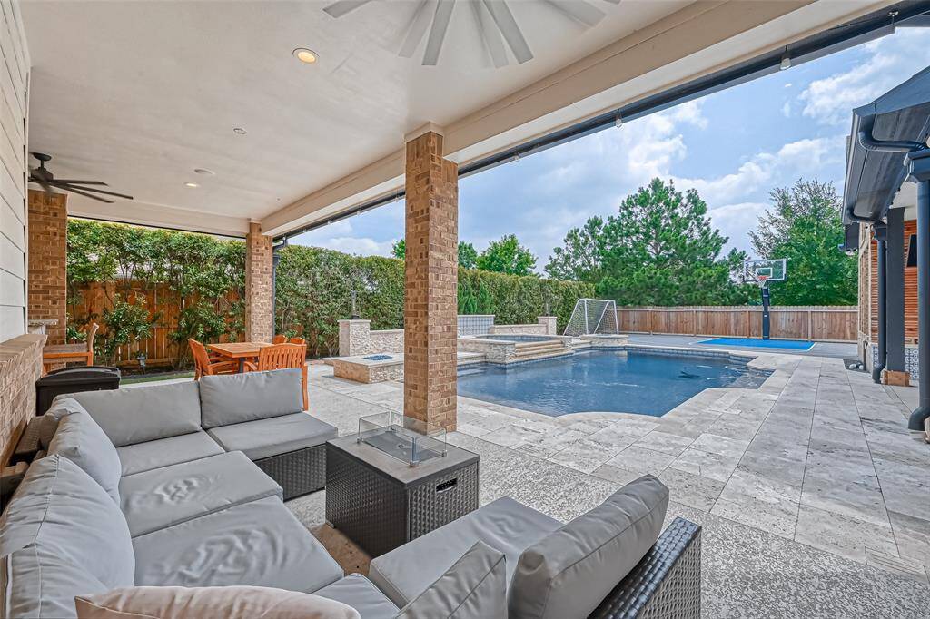 Second outdoor covered seating area with view of pool.