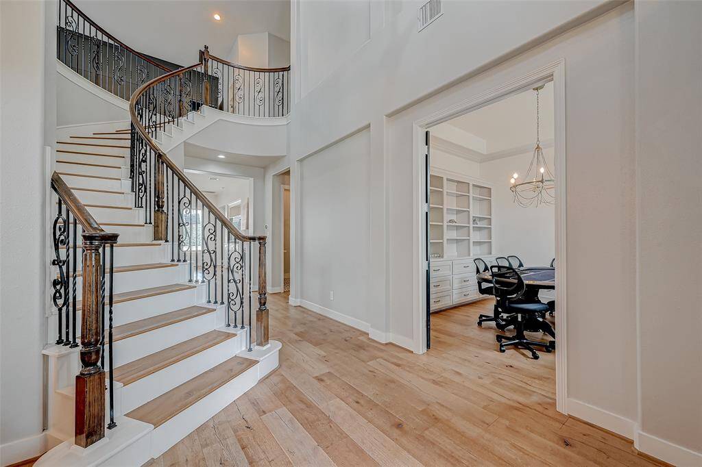 Sweeping staircase with view into office.