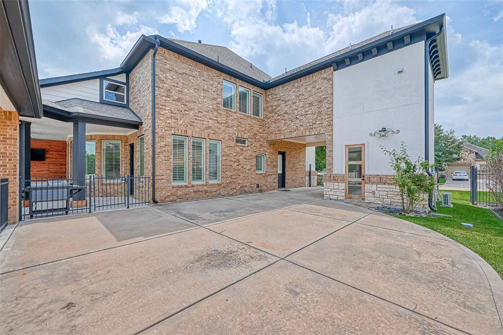 Home from driveway with view of gym door.