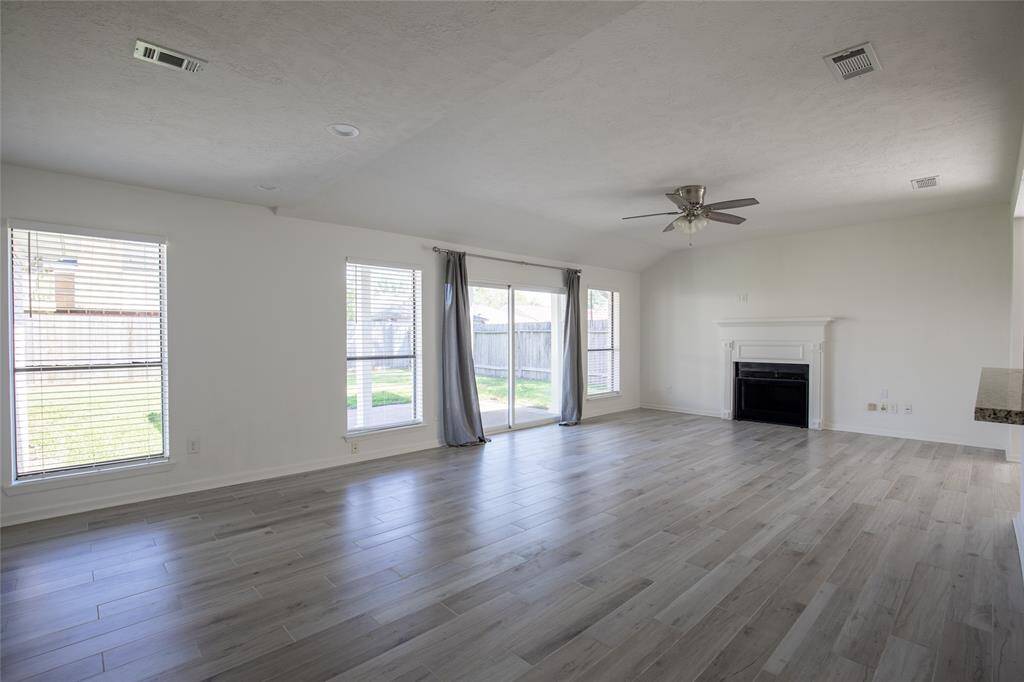 Enjoy warm and cozy gatherings in the large family room with wood burning fireplace
