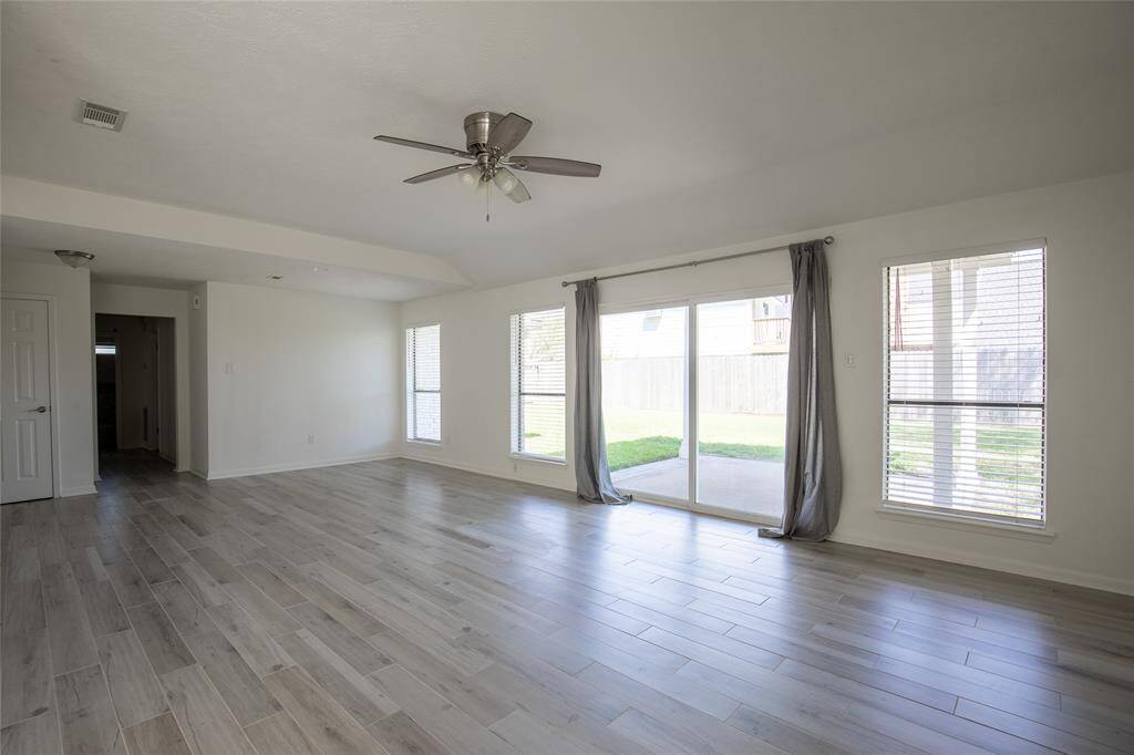 Look out into the open backyard and covered patio from anywhere.