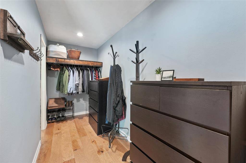 The primary bathroom offers a spacious layout with dual sinks, a generous vanity, and an updated bathtub.