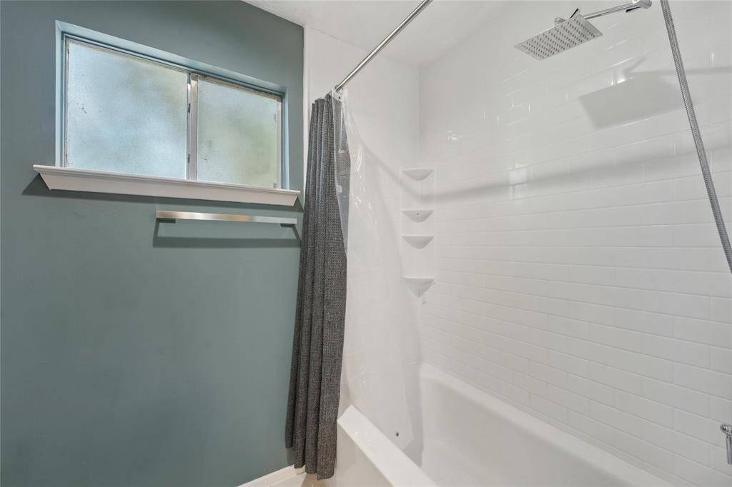 Versatile secondary bedroom currently being used as a home office. Whether you need a workspace, guest room, or creative studio, this room offers flexibility to fit your lifestyle.