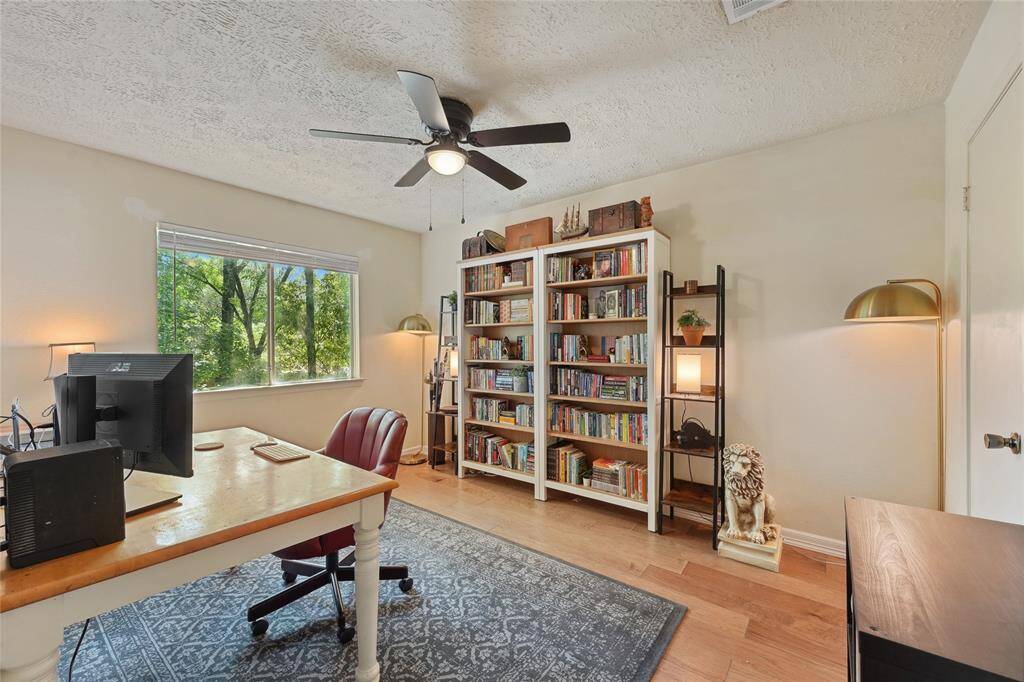 The backyard features a spacious covered patio, perfect for outdoor dining, relaxing with family, or entertaining guests in rain or shine.