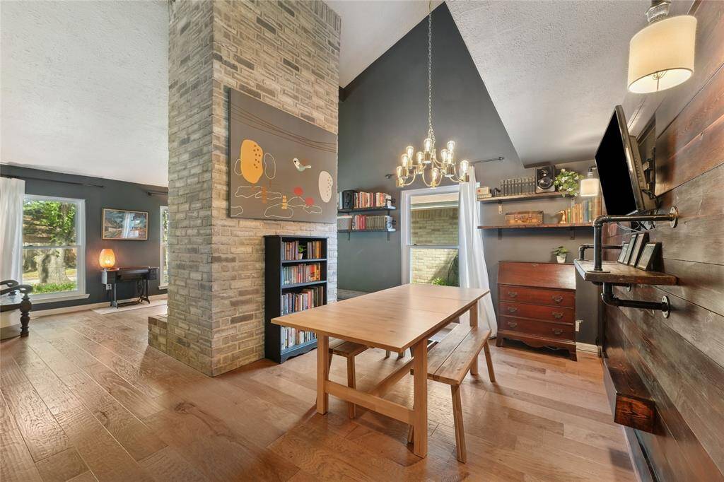 Welcoming entry opens to a formal living and dining area, featuring beautiful wood stairs and a dramatic fireplace that instantly adds character and warmth. A stunning first impression that sets the tone for the rest of the home.