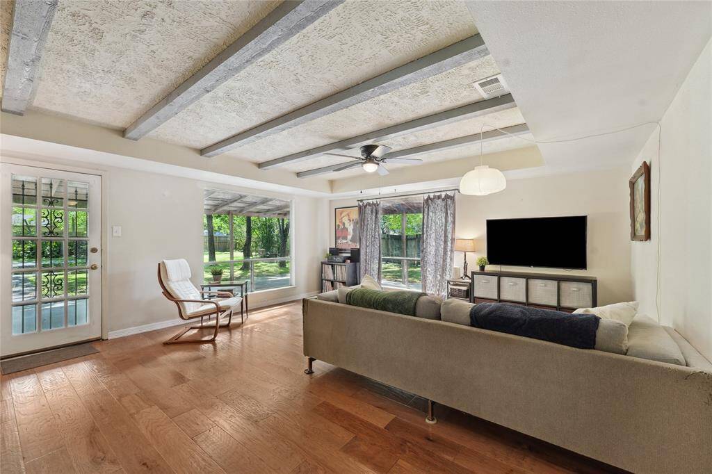 Bright and inviting family room featuring large windows that frame beautiful backyard views.