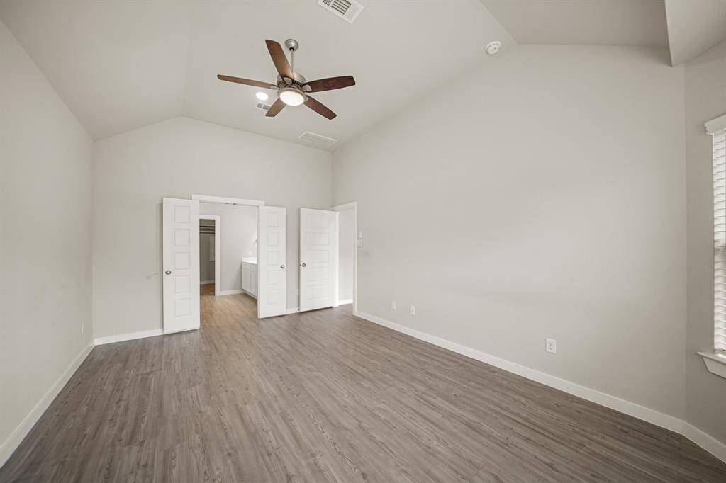 Another view of the Primary Bedroom showcases how spacious the room is.