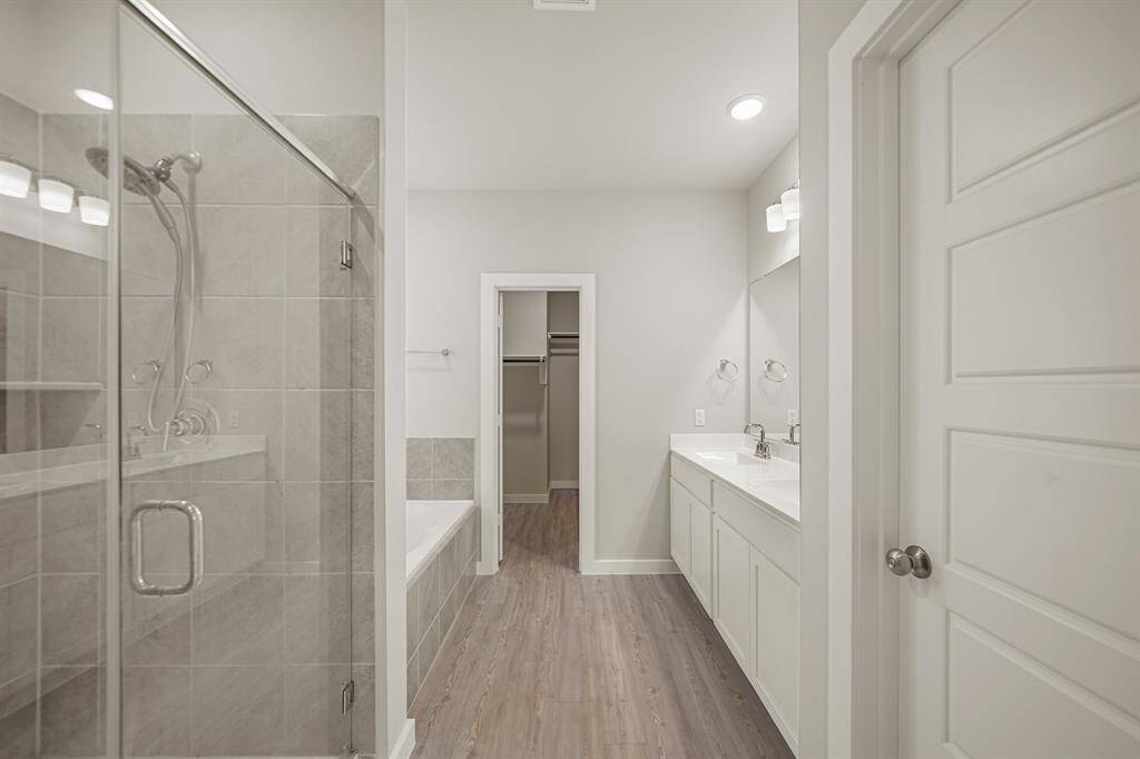 Welcome to your very own retreat! This primary bathroom is highlighted by a beautiful walk-in shower with a gorgeous tile shower wall.