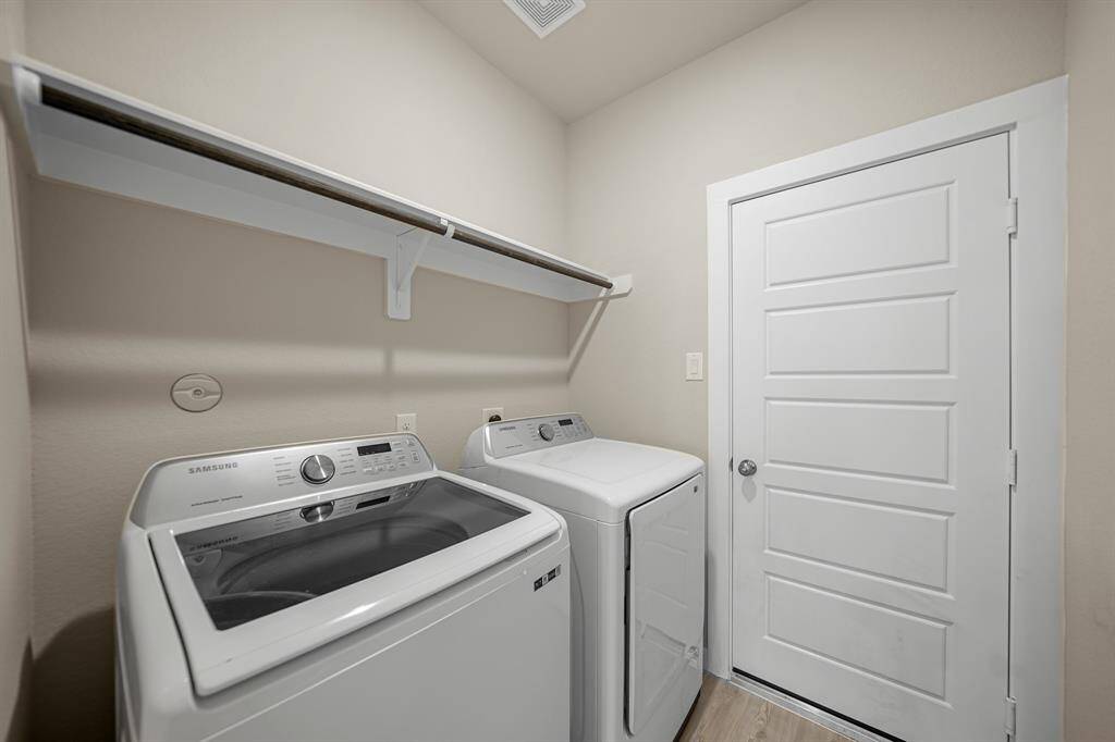 Tucked in nicely is this good looking utility room with enough space to fit separate washer and dryer machines.