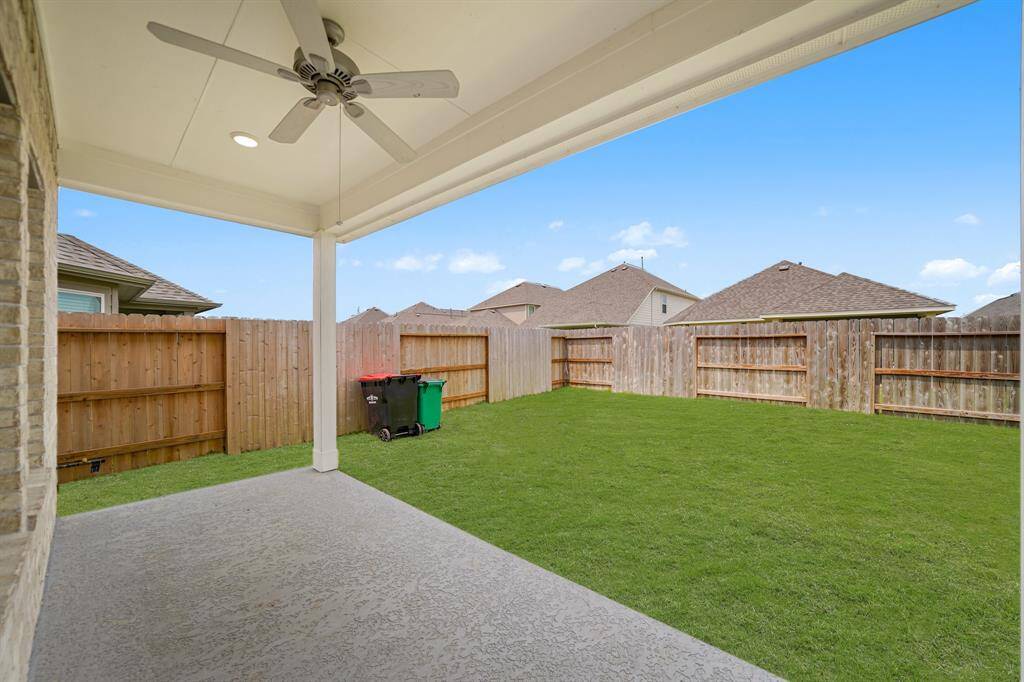 Enjoy entertaining under this fantastic COVERED Patio with a ceiling fan to keep your cooler during the warmer months.