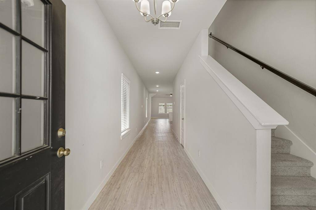 You'll be instantly greeted by beautiful vinyl floors, and a charming stair case.