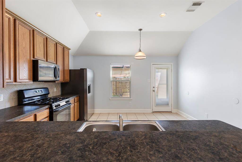 Breakfast bar leading to the kitchen provides more eat-in options.
