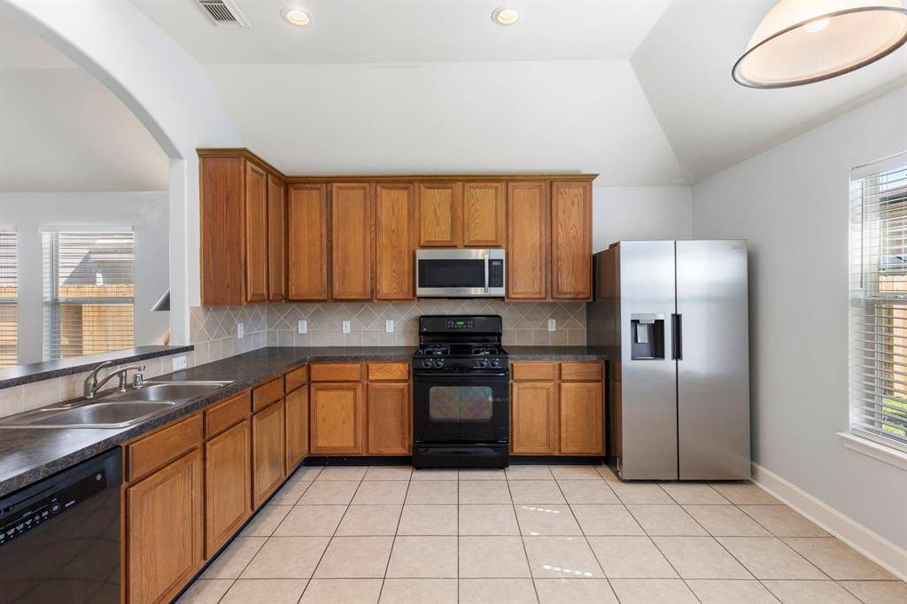 Awesome kitchen with tons of counter and cabinet space and nice tile floors.