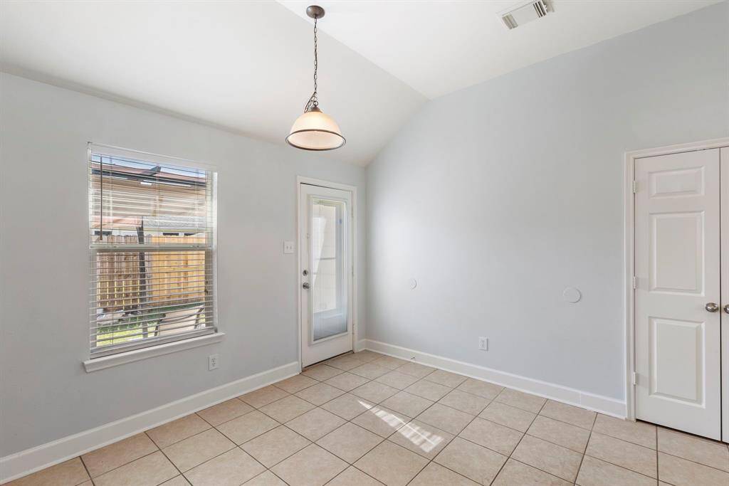 The dining area in the kitchen overlooks the backyard and is filled with beautiful natural light.