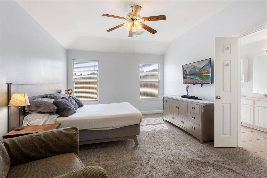 The Primary suite is quietly tucked away at the back of the house providing backyard views.