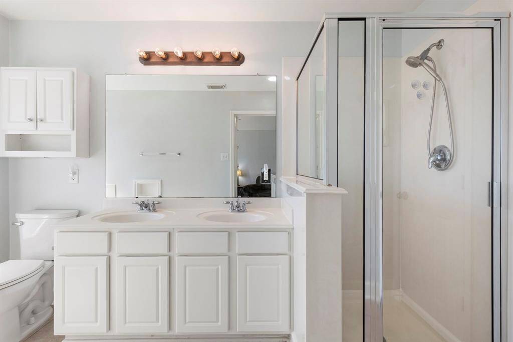 The primary bathroom has double sinks, separate shower and large linen closet.