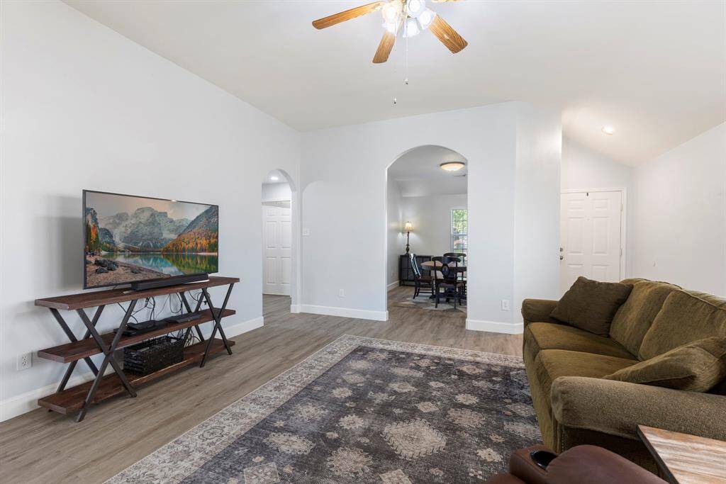 The den features high ceilings and a ceiling fan plus plenty of room for your oversized furniture.