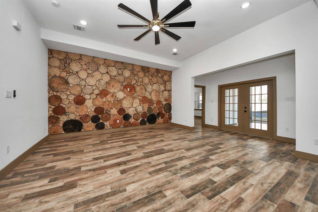 It includes French doors that open to an adjacent area, offering versatile space and natural light.