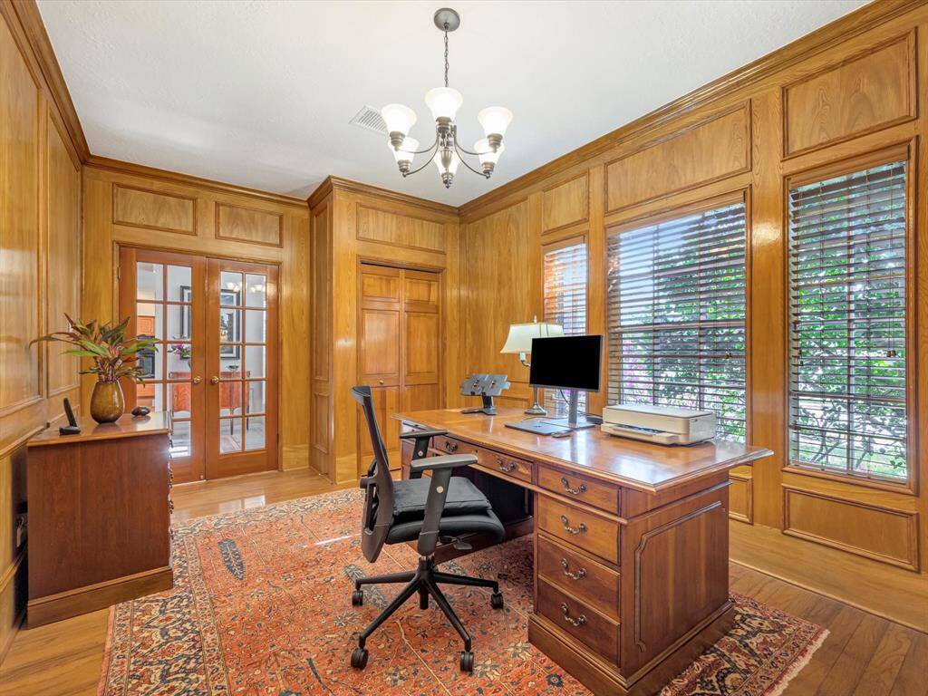Beautiful wood paneled study/office with built in desk/closet, French doors go to front entry.