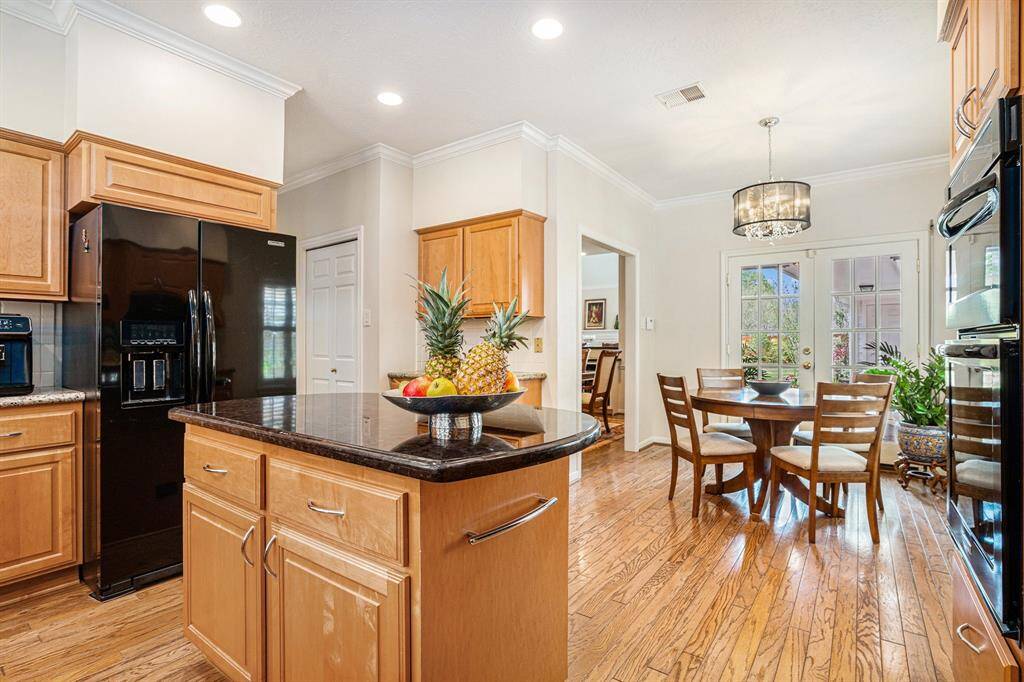 Kitchen overlooking breakfast area. Appliances include electric oven and microwave/convection oven