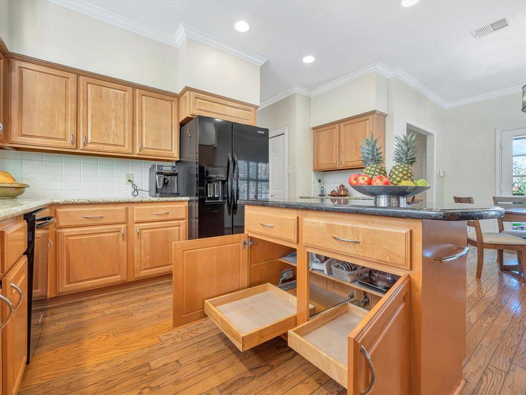 Custom cabinets offer pull out drawers and shelves. Even the cabinet over the refrigerator is pull out.