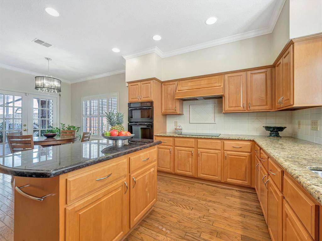 Another view of kitchen, Tons of Granite countertops/work space, oven with microwave/convection oven