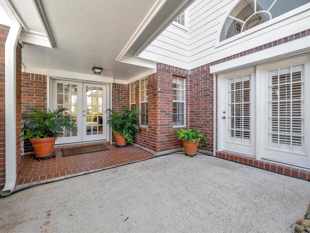 Covered back patio, french doors go to breakfast area and kitchen, doors on right go to large living room. This is a great space for entertaining