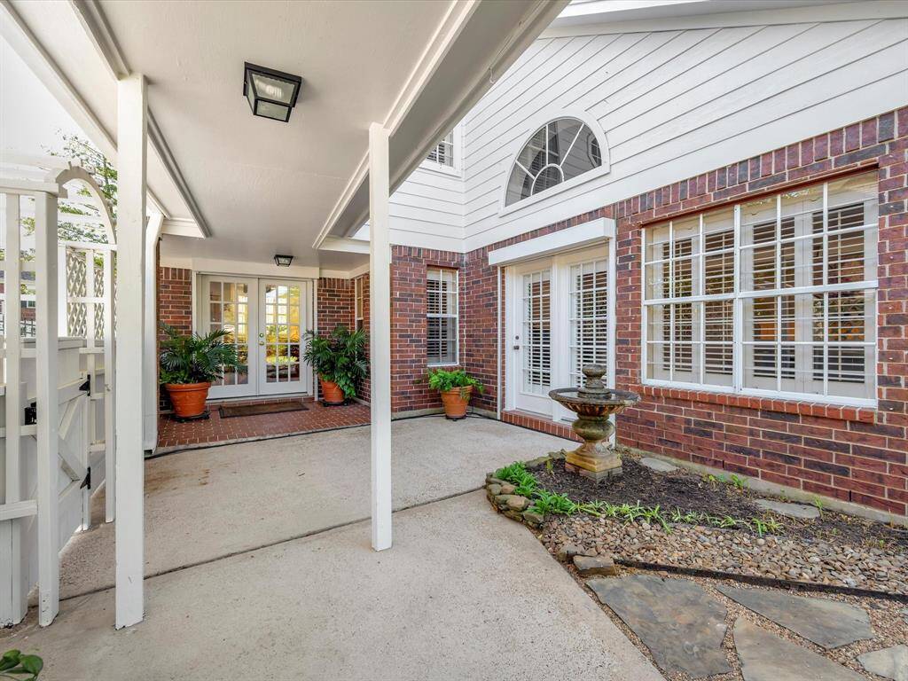 Another view of back patio and breezeway to garage, fountain will stay