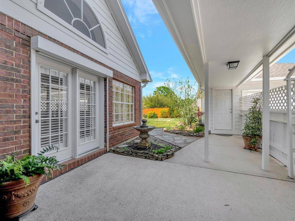 Patio and breezeway to garage, garage offers enclosed air conditioned workshop