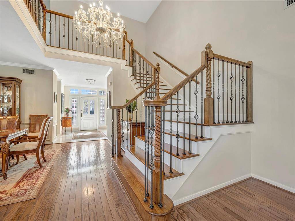 View of entry and staircase from living room.  Note the beautiful chandelier