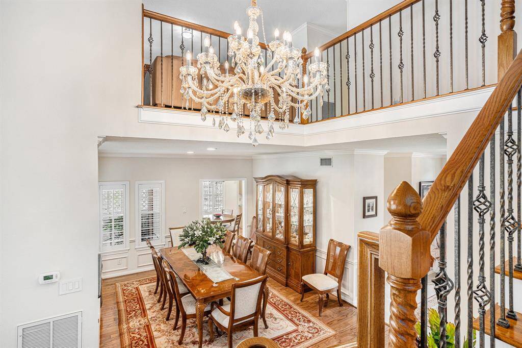 Dining room from staircase.  Chandelier has electronic pully system to lower for ease of cleaning