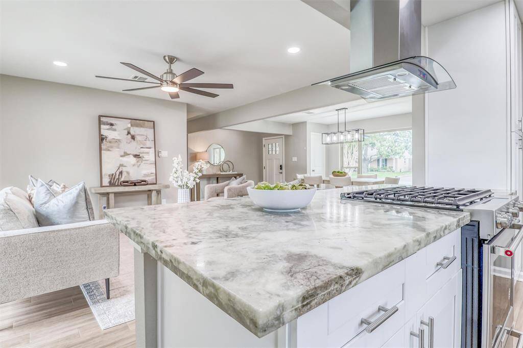 A massive peninsula offers plenty of prep space and doubles as a breakfast bar, while soft-close drawers and generous cabinet storage ensure everything has its place.