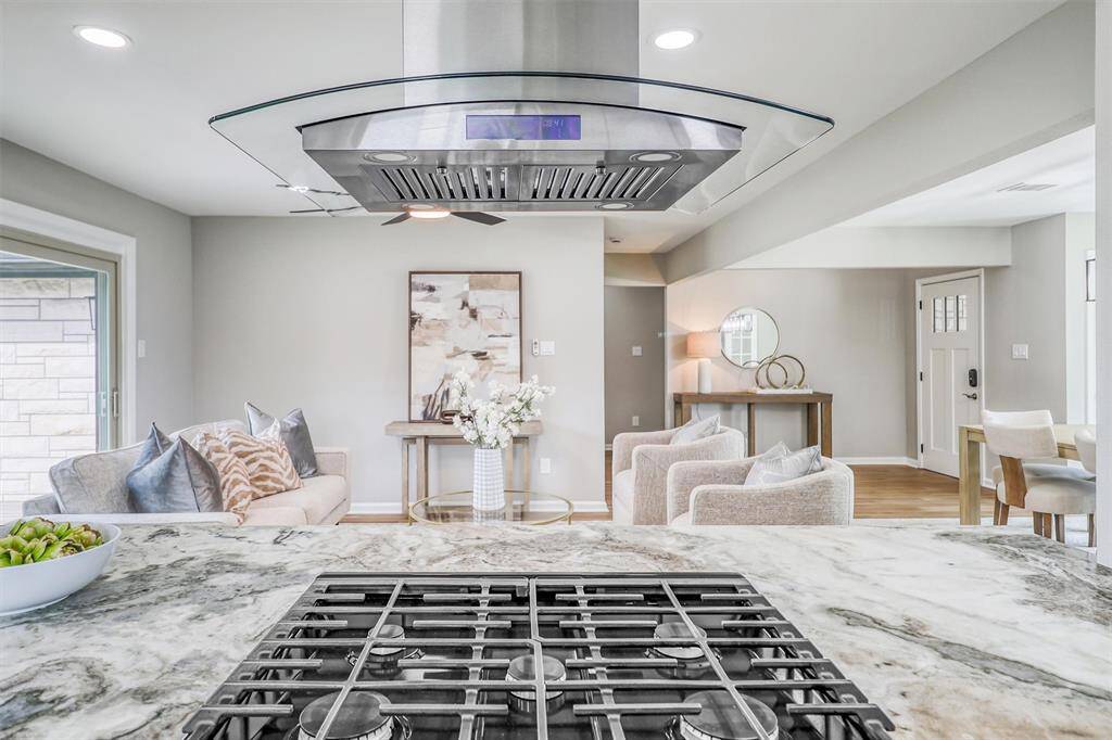 Cook like a pro with premium stainless steel appliances, a 5-burner gas range, and a sleek chimney hood that takes center stage in this stylish culinary space.