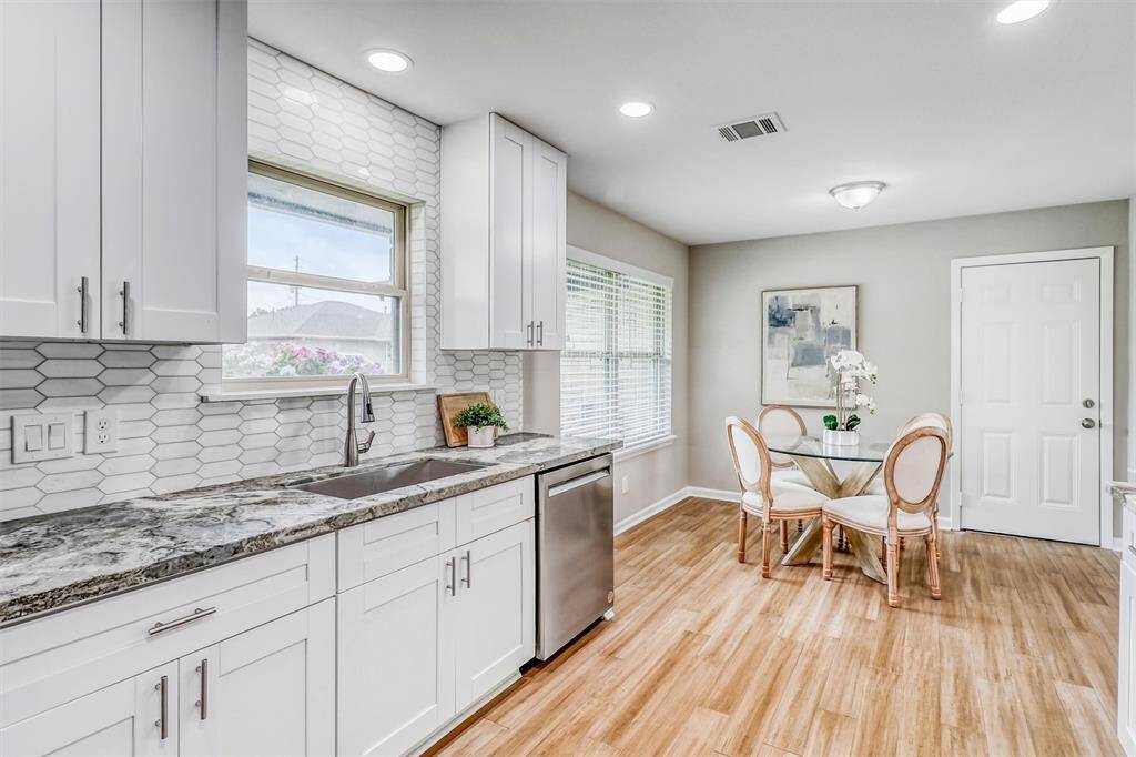 From the bold veining in the countertops to the hexagon tile backsplash, every design choice in this kitchen feels elevated and intentional.