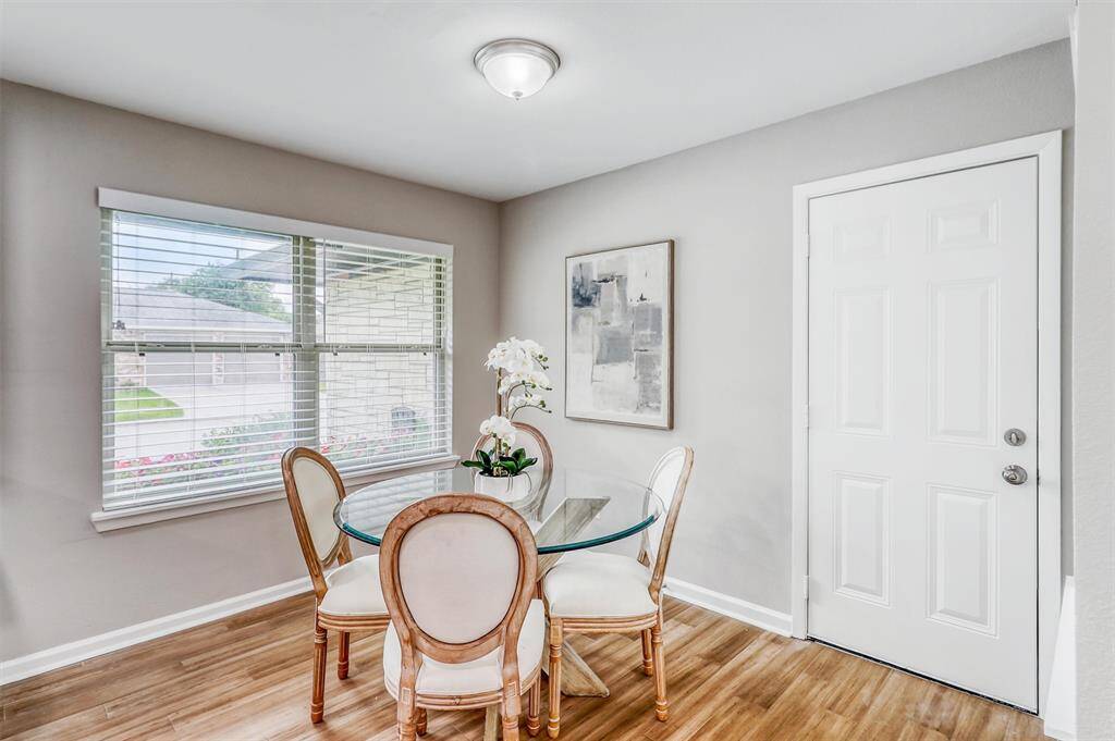The cozy breakfast nook is framed by windows and offers the perfect place for morning coffee, casual meals, or late-night snacks.