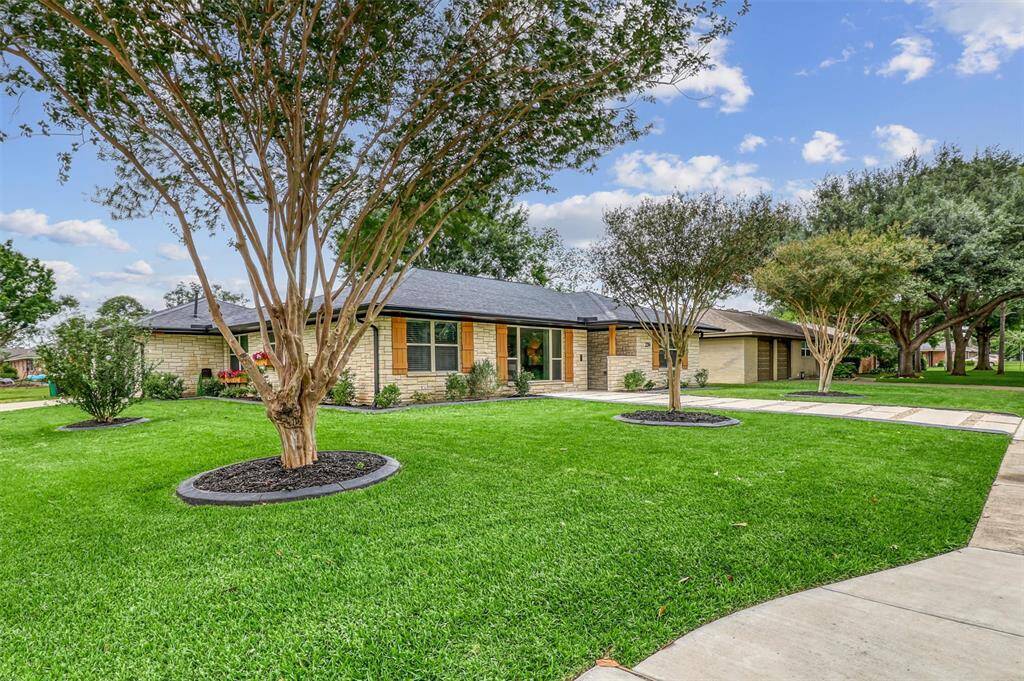 Nestled on a spacious corner lot, this home boasts manicured lawns, mature trees, and a gated side entrance for added convenience and privacy.