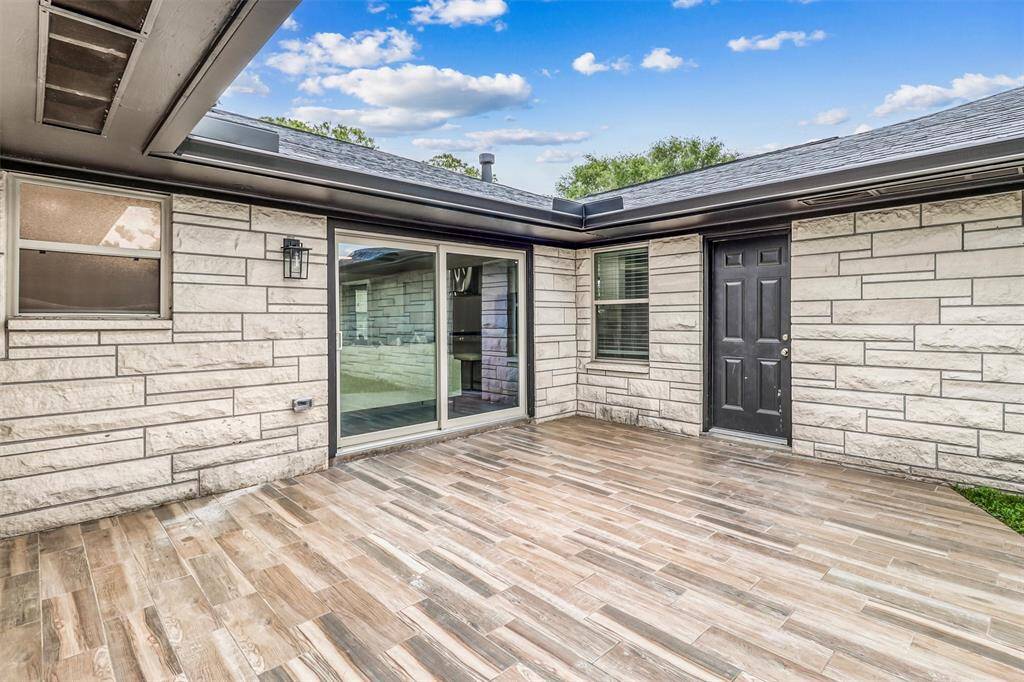The beautiful wood-look tile patio offers a stylish, low-maintenance setting to host guests or enjoy quiet mornings outdoors.