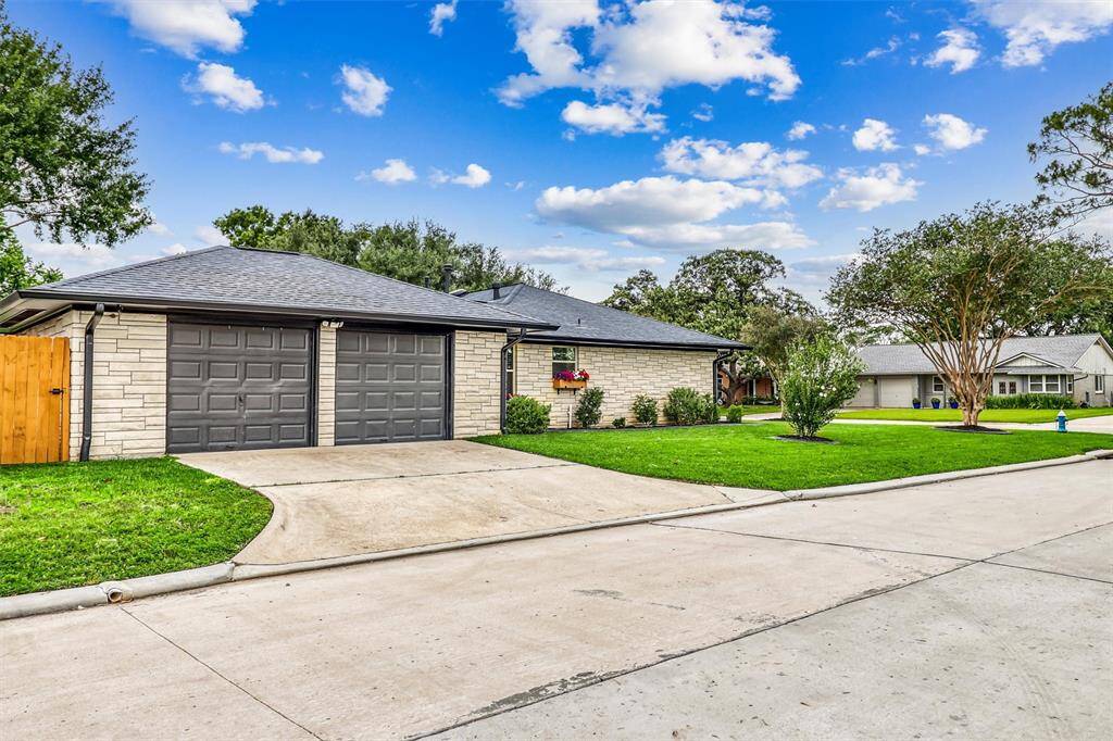 A widened driveway leads to the attached 2-car garage, blending form and function while maintaining the home’s stylish aesthetic.