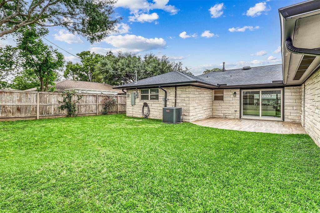 Step out into a spacious, fully fenced backyard with lush green grass, perfect for play, pets, or future garden beds.