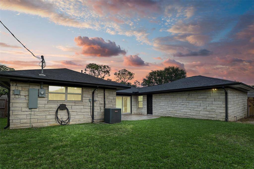 As the sun sets, the backyard transforms into a serene retreat with soft lighting and space to unwind under the stars.