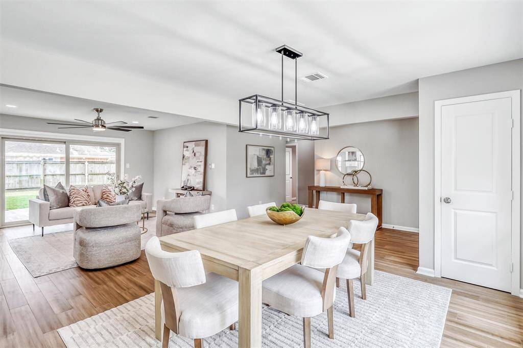 Anchored by a modern chandelier, the formal dining space sits at the heart of the home and flows easily into the living area, making it ideal for gatherings.