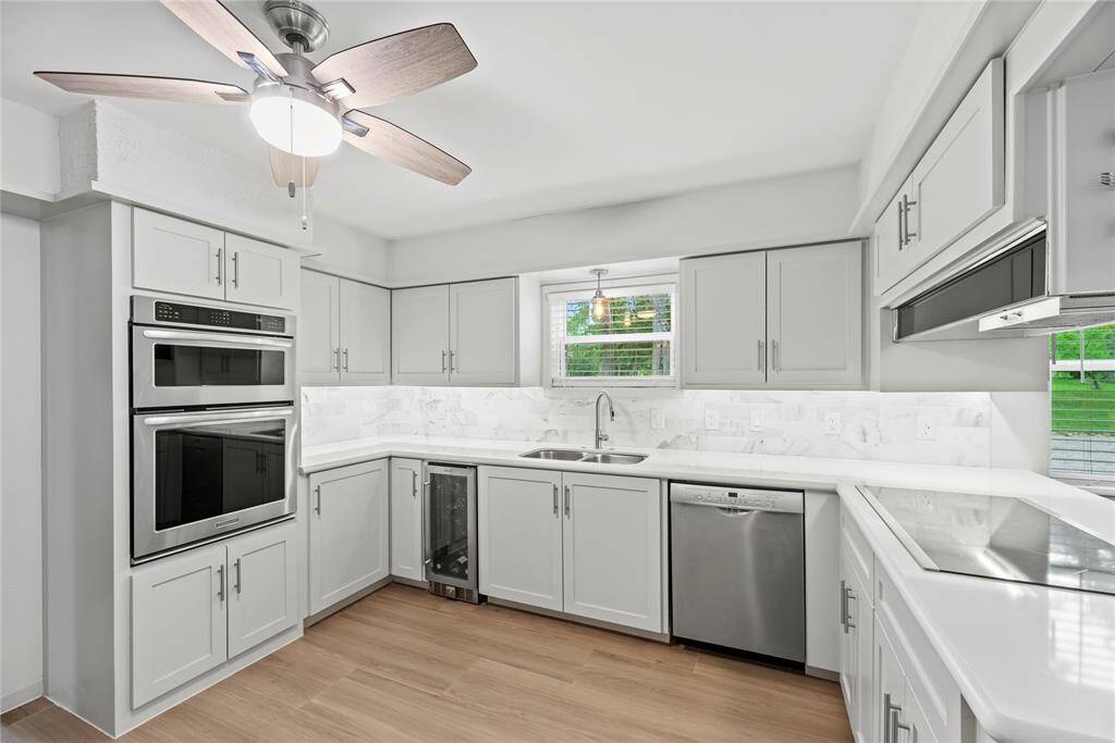 Quartz countertops paired with a coordinating stone backsplash not only provide a durable and elegant surface for food preparation but also add a touch of luxury and sophistication to the kitchen.