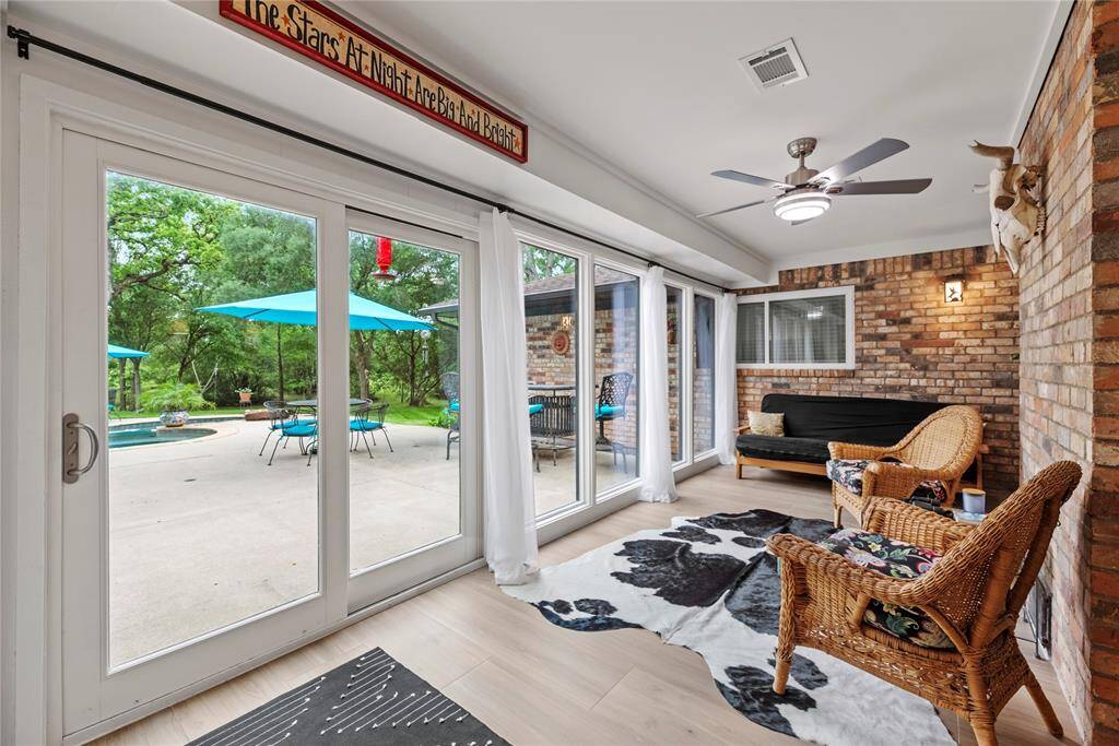 The sunroom offers a serene retreat, seamlessly blending indoor and outdoor living. With expansive windows, it overlooks the stunning backyard oasis, complete with a sparkling pool and lush landscaping.