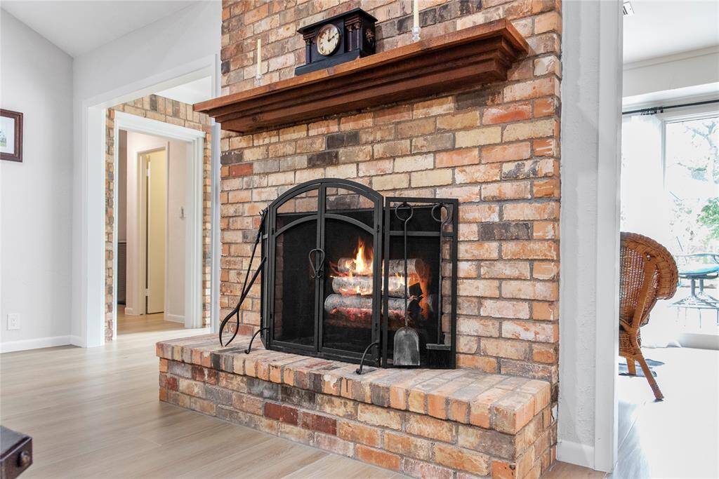 The inviting center fireplace becomes a focal point that anchors the room and invites people to gather and linger, making it a cherished feature of the living area.