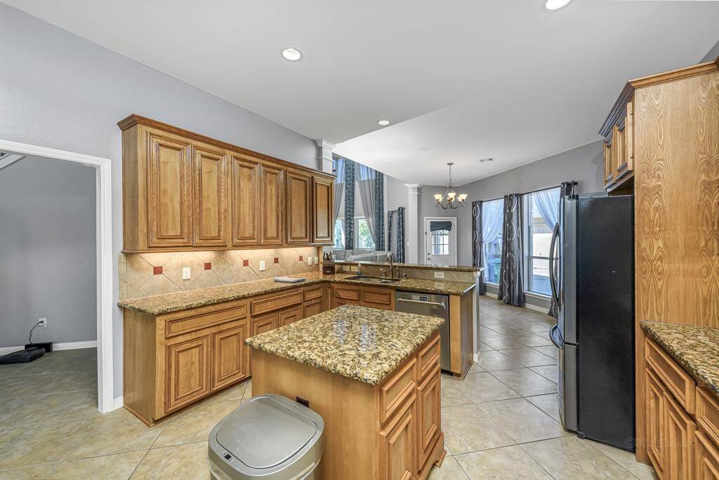 Island in the middle of the kitchen provides additional storage space and a perfect prep area