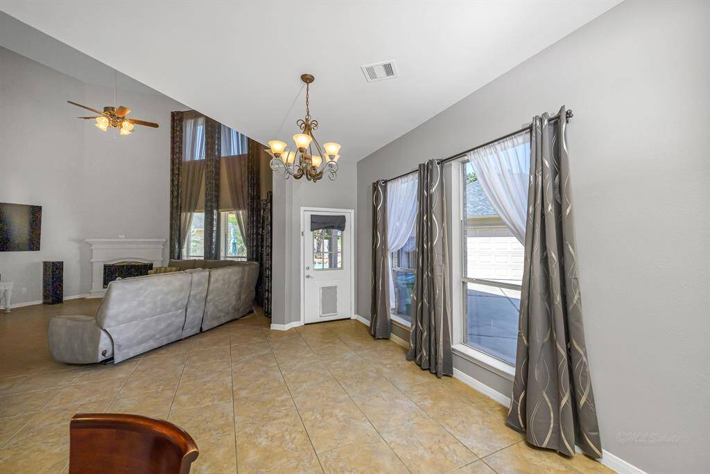 Breakfast area is flooded with natural light from these large windows and just beyond that door is your personal backyard oasis