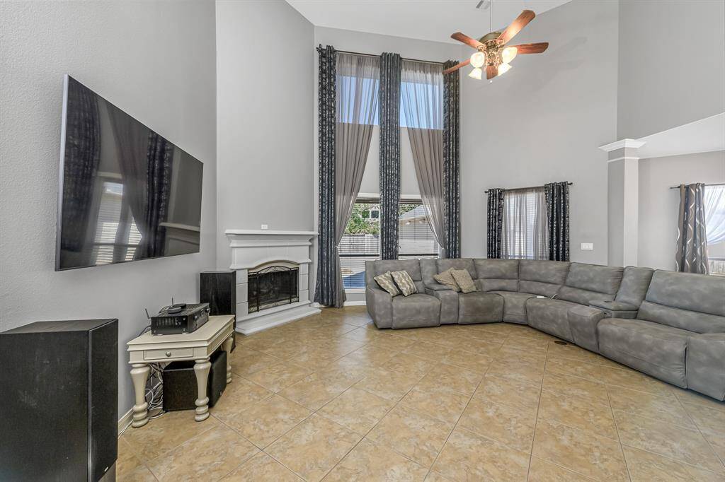 Floor-to-ceiling windows flood the room with natural light and offer unobstructed views of the backyard