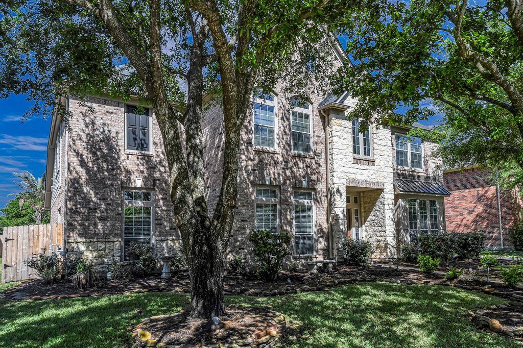 The exterior showcases a rich combination of brick and stone, giving it a warm, textured look