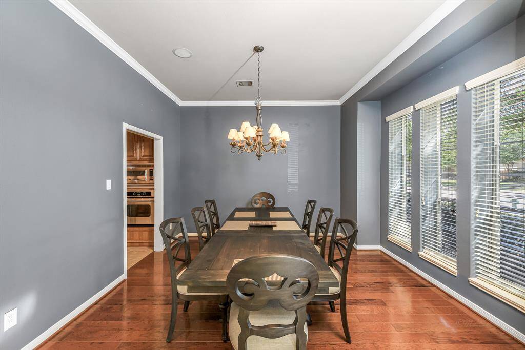 To the right of the front door is the formal dining which is bathed in natural light from the large windows at the front of the home, the engineer wood floors add a touch of elegance to this room
